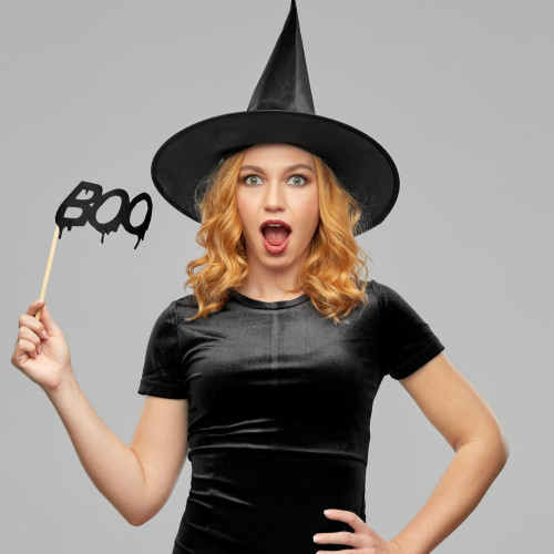 Cute witch with orange curly hair.