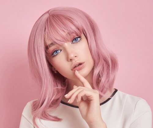 Woman with beautiful pink hair color.