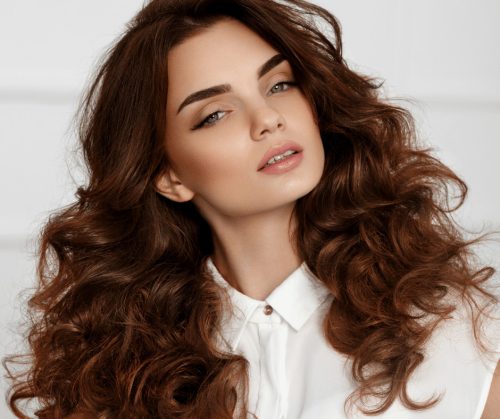 Beautiful woman with brown, wavy hair.
