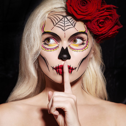 Woman with Halloween skull makeup.