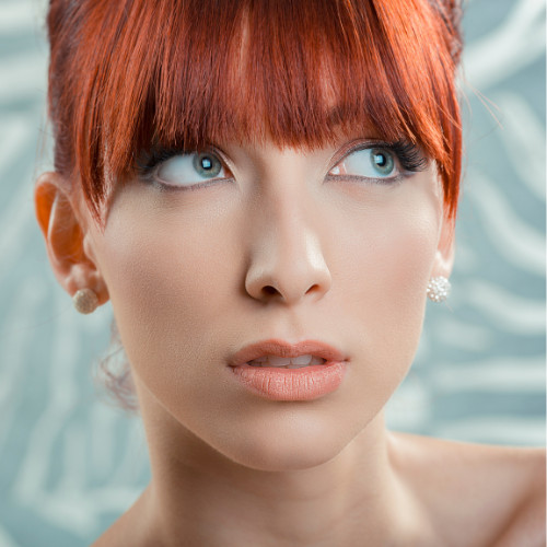 Woman with red wispy bangs.