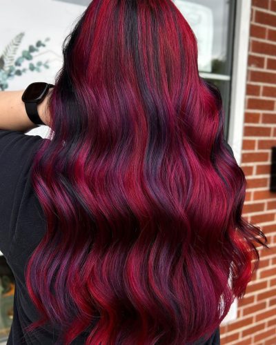 Beautiful red velvet hair color on long wavy hair.
